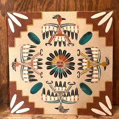 this is an image of a native american art piece on display in a wood frame