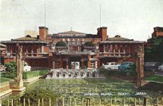 an old photo of a large building in the middle of a park with many fountains