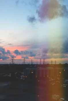 the sun is setting over an industrial area