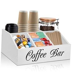 the coffee bar is organized with cups and other things to drink from it's tray