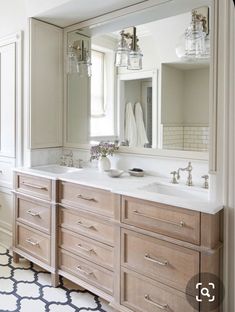 a large bathroom with two sinks and mirrors