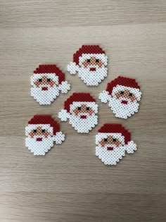 six pixelated santa claus stickers on a wooden table