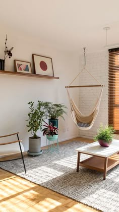 a living room with a hammock hanging from the ceiling