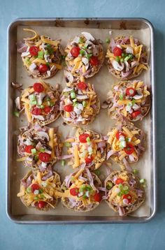 mini pizzas with toppings on a baking sheet