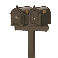 two brown mailboxes with numbers on the front and one number on the back