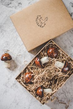 an open box with some mushrooms in it on a marble counter top next to other items