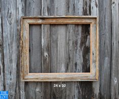 an old wooden frame hanging on the side of a wall with a ruler in front of it