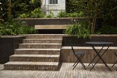 a table and chairs sitting on some steps