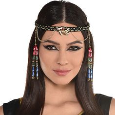 a woman with long hair wearing an egyptian headpiece and beads on her forehead,