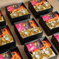 several boxes filled with gold coins on top of a table