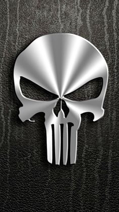 a metal skull on a black leather background