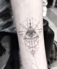 an all seeing eye tattoo on the forearm and arm is shown in black ink with geometric shapes