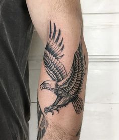 an eagle tattoo is shown on the arm