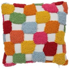 a multicolored square pillow on a white background