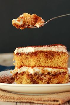 a piece of cake on a plate with a fork in it and someone is about to eat the cake