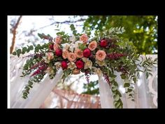 a wedding arch decorated with flowers and greenery