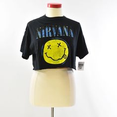 This Womens XL Nirvana Single Sided Graphic Cropped Tee Shirt in Black is perfect for those who love rock, music, and grunge. The shirt has short sleeves, a crew neck, and a pullover closure. It is made of 100% cotton and is a regular fit. The shirt is great for casual occasions and can be worn in the summer, fall, and spring seasons. It is a solid pattern with casual sleeves and is not vintage. The brand is unknown, but the shirt is of great quality. The size type is regular and the shirt is categorized under Tops, Women's Clothing, and Women. Get your hands on this stylish shirt to add to your wardrobe today! Chest: 48" Length: 18" Cropped Tee Shirt, Stylish Shirt, Cropped Tee, Spring Season, Stylish Shirts, Solid Pattern, Crop Tee, Nirvana, Rock Music