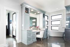 a bathroom with a tub, sink, and mirror in it's center area