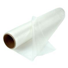 a roll of white tissue sitting on top of a piece of plastic wrapper paper