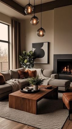 a living room filled with furniture and a fire place next to a large window on top of a hard wood floor