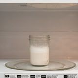 a glass jar sitting on top of a microwave