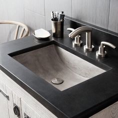 a bathroom sink sitting on top of a wooden counter