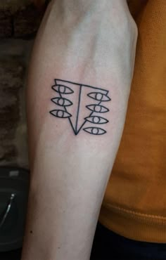 a person with a tattoo on their arm that has arrows in the shape of an arrow