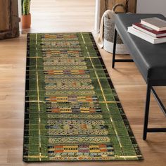 a green area rug on the floor in a living room