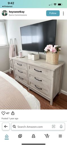 a flat screen tv sitting on top of a wooden dresser