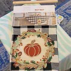 a table with a quilted pumpkin on it