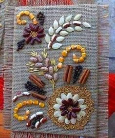 a close up of a piece of art made out of beads and fabric with flowers on it