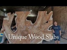 two people standing next to a large piece of wood