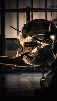 an airplane is parked in the dark with its propeller still attached to it's side