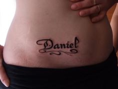 a woman's stomach with the word danielle written on it, in cursive font