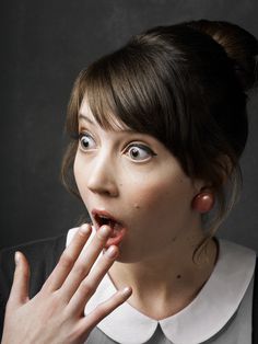 a woman making a funny face with her hands