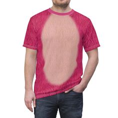 a man standing with his hands in his pockets and wearing a pink t - shirt