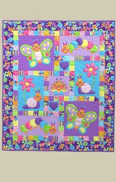 a colorful quilt with flowers and butterflies on it