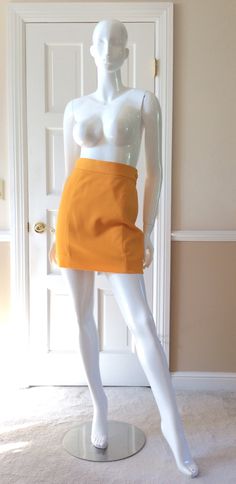 "This vintage Moschino skirt is in his iconic taxi cab/school bus yellow.  Fully lined in yellow rayon.  Side zipper with self button.  Front and back shaping seams.  Measurements -  Waist - 27' Hips - 36\" Length - 18\"" Chic Fitted School Skirt, Chic Fitted Skirt For School, Chic Fitted School Skort, Chic Fitted Skort For School, Retro Fitted Short Skirt, Chic Fitted Yellow Pencil Skirt, Chic Yellow Fitted Pencil Skirt, Yellow Workwear Bottoms Shorts, Fitted Yellow Pencil Skirt For Spring