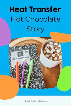 a cup of hot chocolate with marshmallows on top and a book next to it