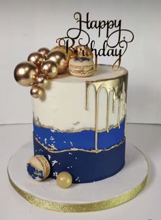 a birthday cake decorated with gold and blue icing