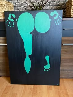 a black and green painting with footprints on it