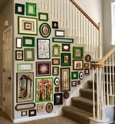 a staircase with many pictures on the wall