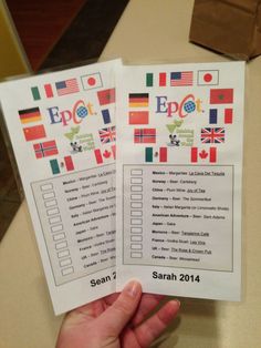 someone holding up two pamphlets for the eport expo in germany and england, both with flags on them