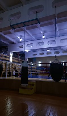 an empty boxing ring is lit up at night