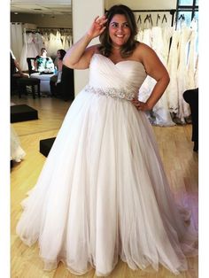 a woman in a white dress posing for the camera