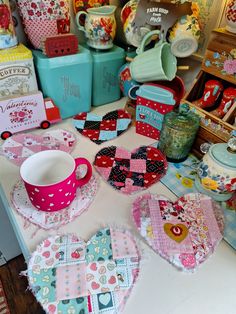 a table topped with lots of different types of heart shaped plates and cups next to each other