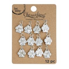 Purchase the Charmalong™ Rhodium Paw Charms by Bead Landing™ at Michaels. Customize your handmade jewelry with these cute paw charms by Bead Landing. Customize your handmade jewelry with these cute paw charms by Bead Landing. Add them to a matching chain to create a lovely necklace. Details:Rhodium , 12.6mm x 15mm, 12 charms, Zinc alloy, iron and glass | Charmalong™ Rhodium Paw Charms By Bead Landing™ | Michaels® Adjustable Paw Print Jewelry For Gift, Cheap Adjustable Jewelry With Paw Print, Sterling Silver Paw Print Jewelry For Gifts, Dog Paw Pendant, Paw Print Charm, Diy Bracelet Designs, Lovely Necklace, Diy Bracelets, Bracelet Designs