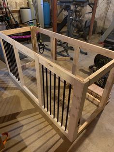 a wooden gate is being built in a garage