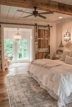 a large bed sitting inside of a bedroom on top of a hard wood floored floor