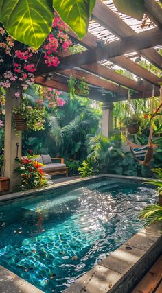 an outdoor swimming pool surrounded by tropical plants